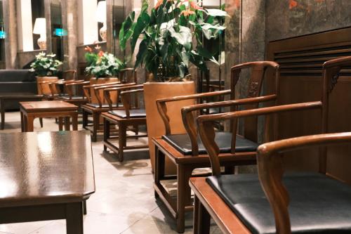 a row of chairs in a restaurant with plants at Kurashiki Royal Art Hotel in Kurashiki