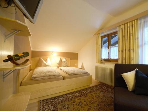 a small bedroom with a bed and a window at Apartment house Sylvia, Flachau in Flachau