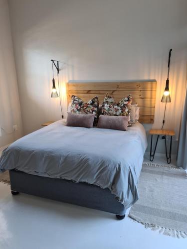 a bedroom with a large bed with pillows on it at Still Bay East Beach Apartment in Stilbaai