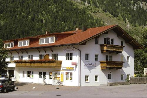 a large white building with a red roof at Apartment in Zugspitz Arena near Highline 179 in Bichlbach