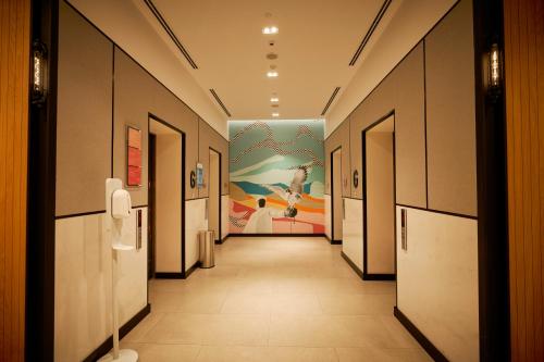 a hallway in a building with a painting on the wall at Citymax Hotel Business Bay in Dubai