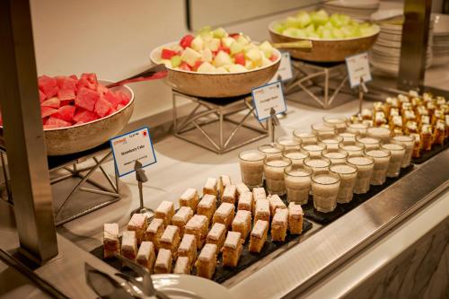 a buffet with various desserts and fruit on display at Citymax Hotel Business Bay in Dubai