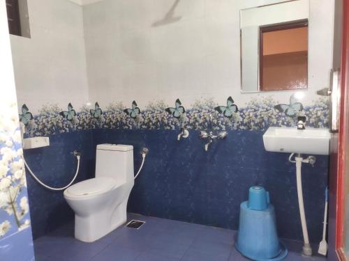 a bathroom with a toilet and a sink at Spices Garden Homestay & Plantation Tour in Madikeri