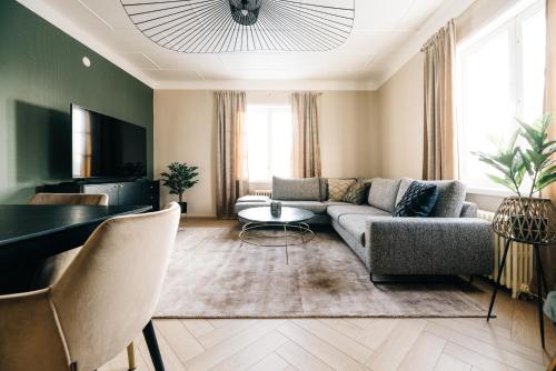 a living room with a couch and a table at Lilla Rantala, luksusmajoitus keskustassa in Seinäjoki