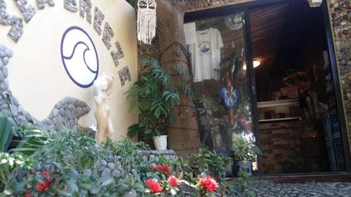 a store front with flowers and plants in front of it at Seabreeze Beachfront Home and Cottages new management in San Juan