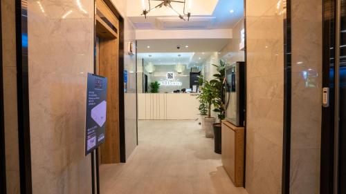 a hallway in a store with a sign on the door at LABE Hotel in Jeonju