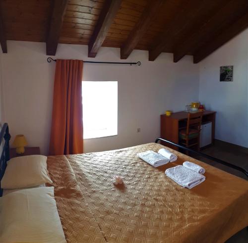 a bedroom with a bed with two towels on it at Guest House Provišta in Veli Iž