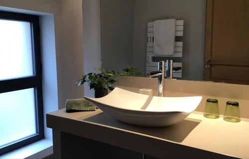 a bathroom with a bowl sink on a counter at La Grange Saint Martin in Fontaine-le-Port