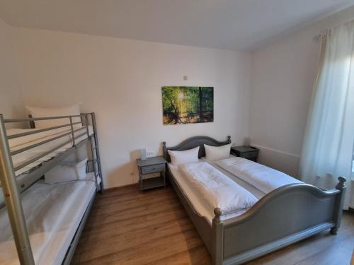 a bedroom with a bed and a bunk bed at Hotel & Restaurant Tanne in Fischingen