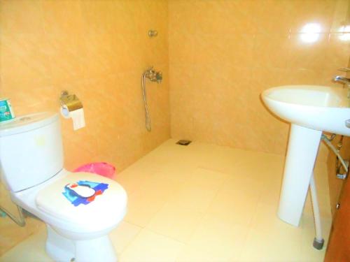 a bathroom with a toilet and a sink at Hotel White Sand Beach Nilaveli in Nilaveli