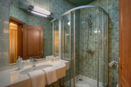 a bathroom with a sink and a shower at RIVER INN RESORT AND SPA in Nabran