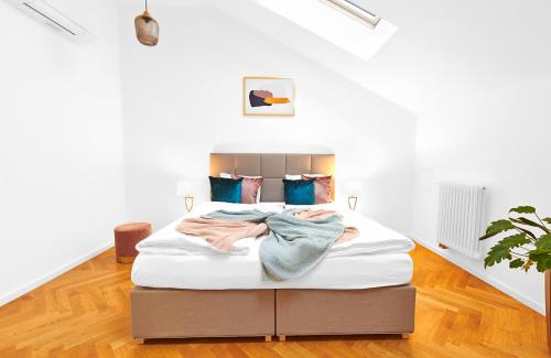 a large bed in a room with white walls at Residence Dlouha - Old Town in Prague