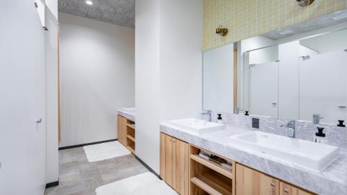 a bathroom with two sinks and a mirror at EIGHT POINT INN Kanazawa in Kanazawa
