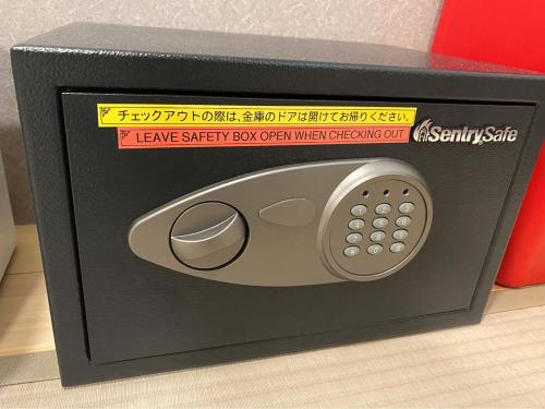 a small black box with a remote control in it at Wild Cherry Blossom-HOSTEL,TOKYO KOGANEI- in Koganei