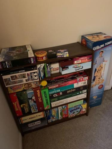 a pile of books sitting on top of a table at Lovely two-story house with spacious backyard in Summerville