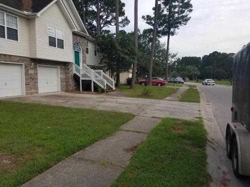 a house on a street with a driveway at Lovely two-story house with spacious backyard in Summerville