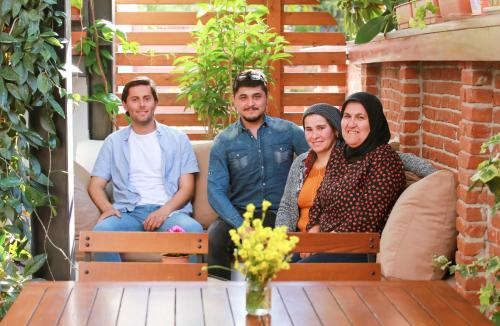 a group of four people sitting on a bench at Mare Nostrum in Kas