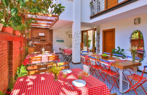 a patio with tables and chairs with red and white table cloth at Mare Nostrum Apart in Kaş