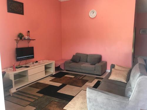 a living room with a couch and a tv at Homestay Tok Penghulu in Kuantan