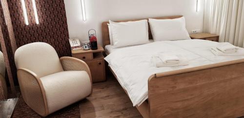a bedroom with a bed and a chair in it at ConnectIN Apartments in Pale