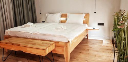 a bedroom with a bed with two phones on it at ConnectIN Apartments in Pale