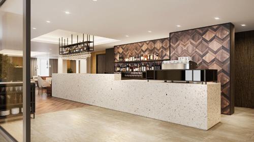 a lobby with a counter and a bar at Hotel de Schelde in Cadzand-Bad