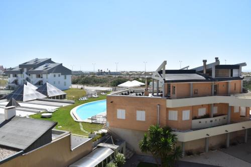 an aerial view of a building with a swimming pool at QH Praia de Quiaios in Praia de Quiaios