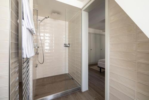 a shower with a glass door in a bathroom at EMA House Serviced Apartments Superior Unterstrass in Zürich