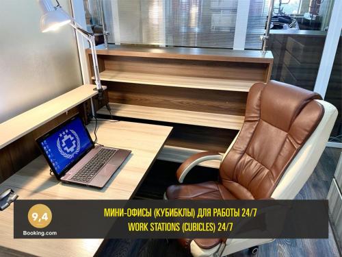 a laptop computer sitting on a desk in a room at LES Mini Hotel in Almaty