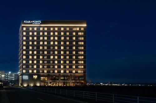 a lit up building with a sign on top of it at Four Points by Sheraton Nagoya, Chubu International Airport in Tokoname