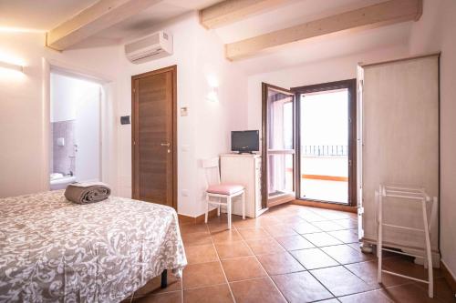 a bedroom with a bed and a room with a balcony at La Dolce Vista Bed&Breakfast in Cannara