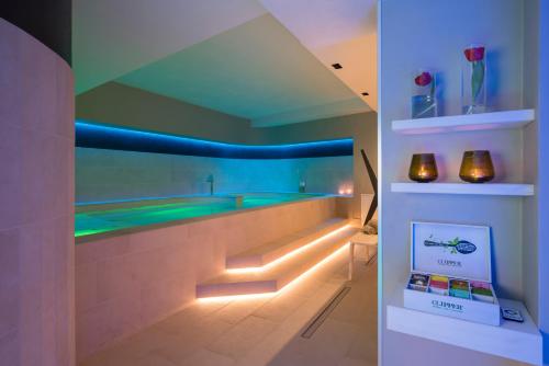 a bathroom with a bath tub with a blue ceiling at Hotel Imperiale Rimini & SPA in Rimini