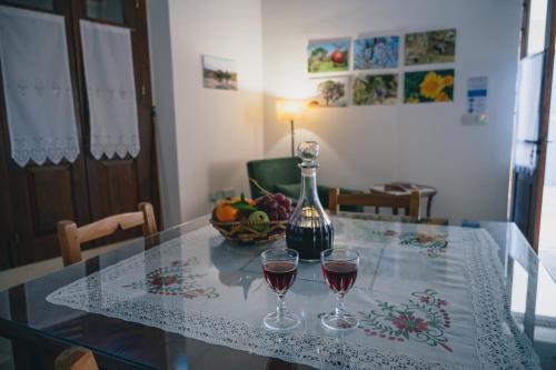 a table with two glasses of red wine on it at Rothkia's Home in Parekklisha