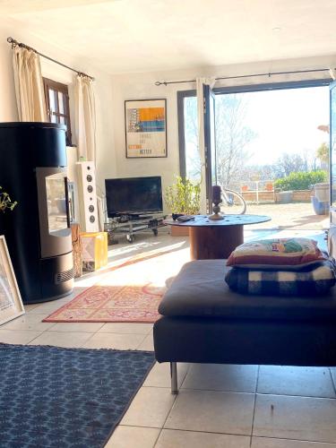 a living room with a couch and a large window at Appartement de 2 chambres avec vue sur la ville piscine partagee et jardin clos a Gaillac in Gaillac