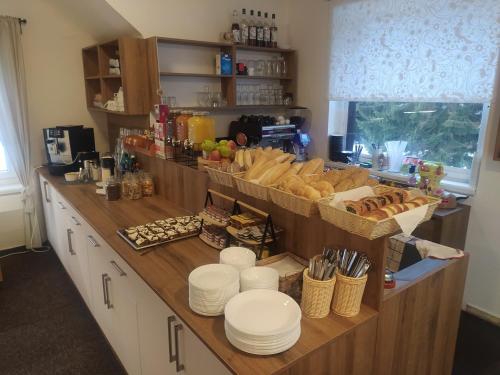 a kitchen with a counter with bread and other foods at Na Losenici in Nicov