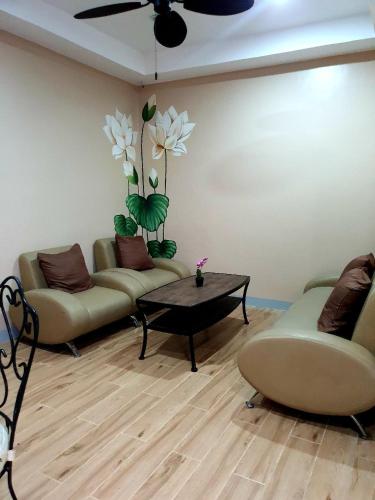 a living room with two couches and a table at Luis miguel's place in Dumaguete