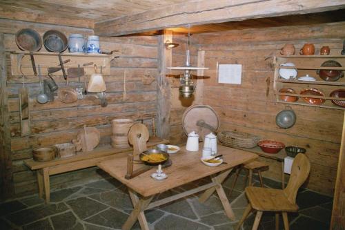 a wooden room with a wooden table and chairs at Swiss Heidi Hotel in Maienfeld