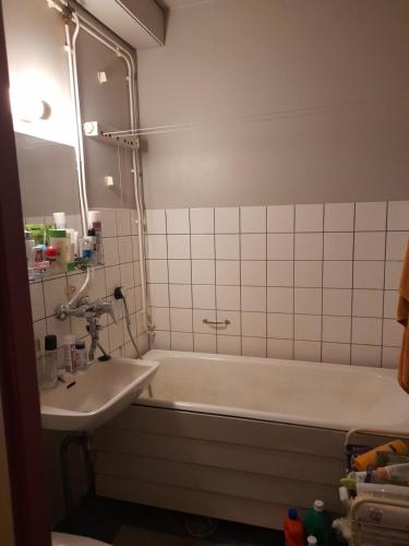 a bathroom with a bath tub and a sink at Retroyksiö in Björkboda