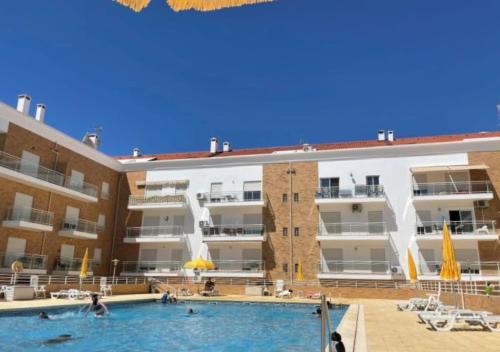 a swimming pool in front of a building at Paradise Found - Stunning 3 Bedroom Apartment in Vila Real de Santo António in Vila Real de Santo António