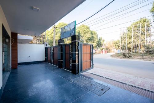 a building with a large window on the side of a street at The Palms Inn I Near Medanta Medicity I Sec-38 in Gurgaon
