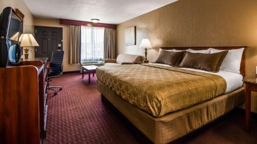 a hotel room with a bed and a television at Best Western El Reno in El Reno