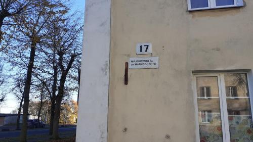 a sign on the side of a building with a window at Majakovski Junior Suite in Sillamäe