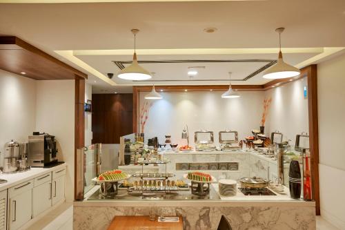 a kitchen with a counter with food on it at Citymax Sharjah in Sharjah