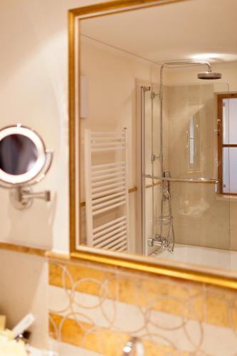 a mirror over a sink in a bathroom at Hotel Solaria Ischgl - 4 superior in Ischgl