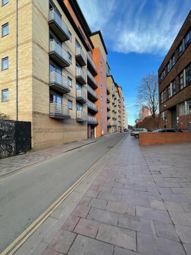 an empty street in a city with buildings at Quality City Leicester in Leicester