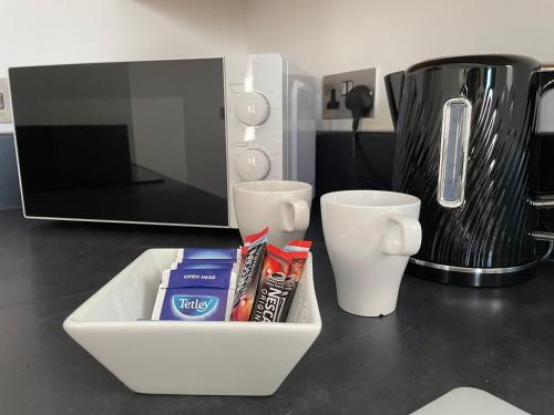 a counter top with a tray of food and a microwave at Quality City Leicester in Leicester