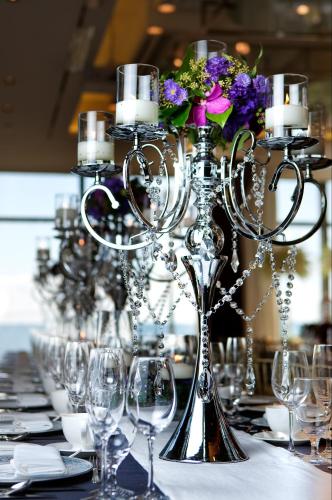 a long table with wine glasses and flowers on it at Paradise Hotel Busan in Busan
