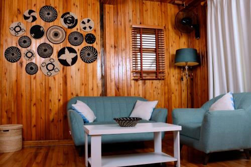 a living room with two chairs and a table at Pelican Lodge & Marina in Entebbe