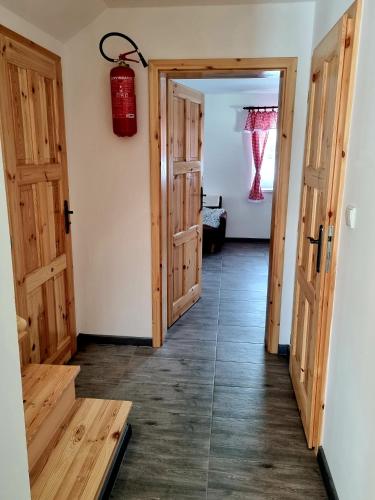 a hallway with two doors and a fire extinguisher at Dům a chatka pod Smrkem in Nové Město pod Smrkem