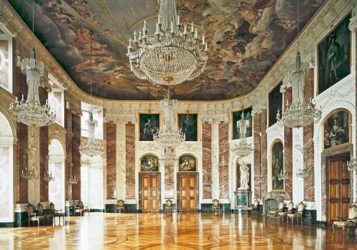 a large room with a chandelier and paintings on the ceilings at Hotel Kurpfalzstuben in Mannheim